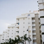 Streets with architecture of the resort town buildings and tropical greenery.